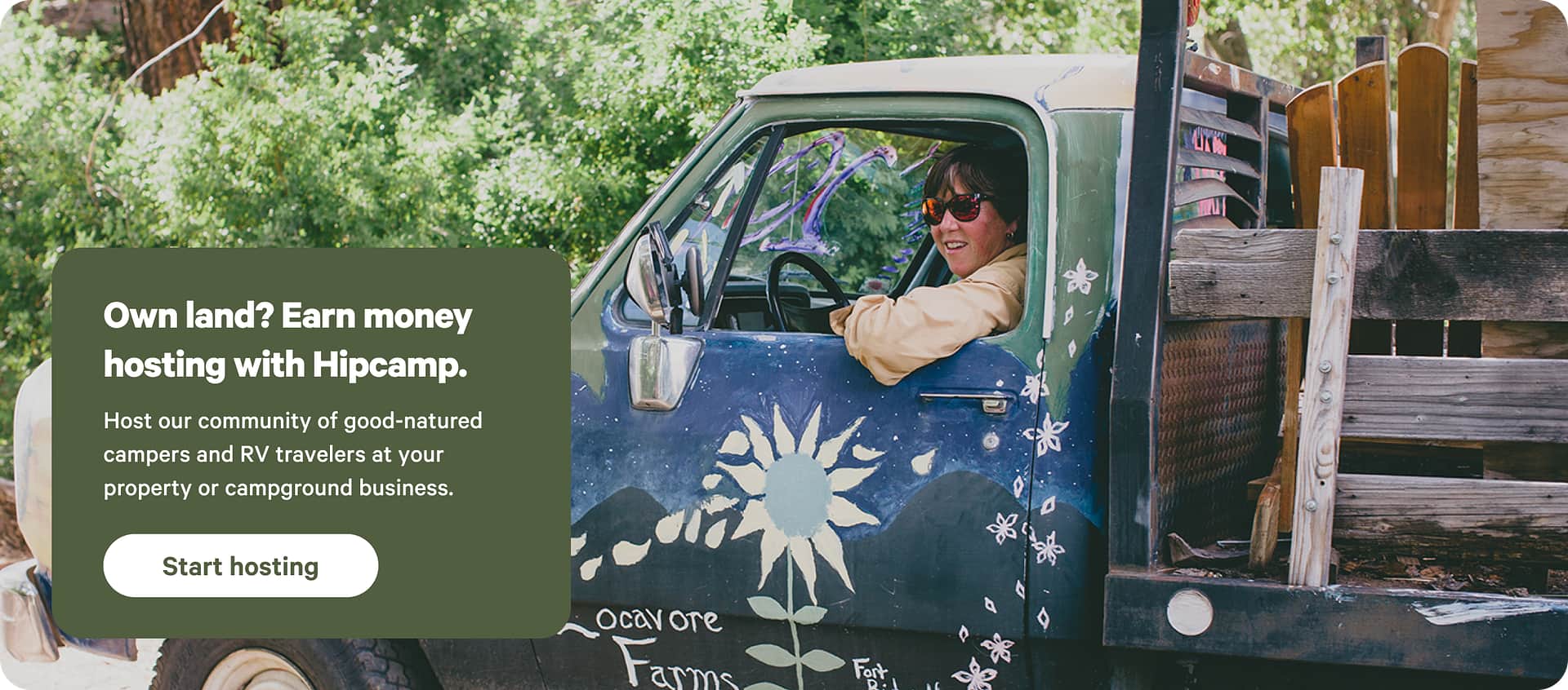 Happy farmer sitting in a truck in a grassy field