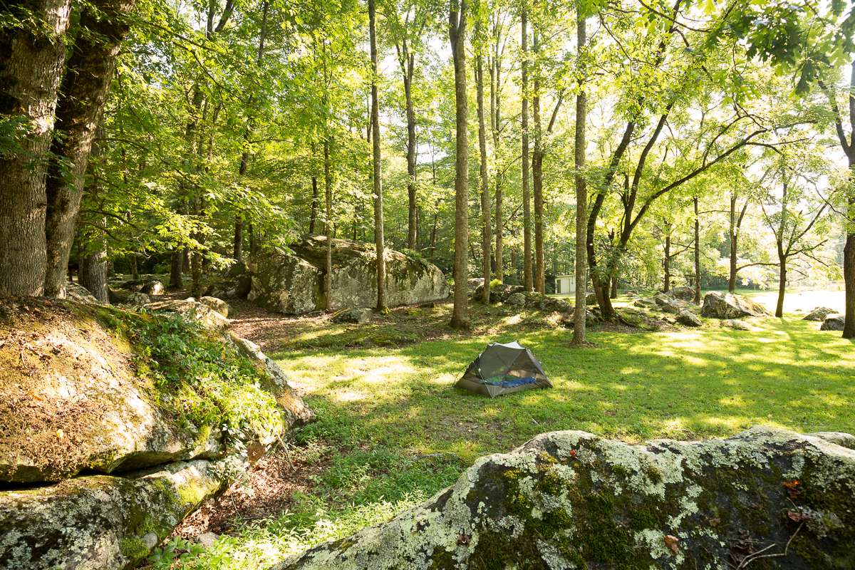 Tent site surrounded by giant, mossy boulders. 