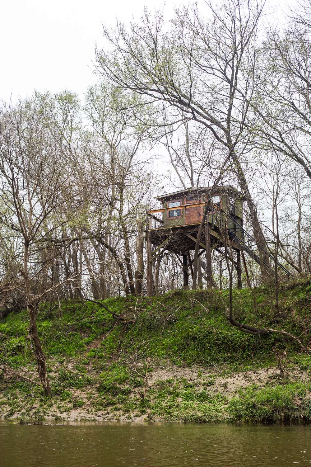 View of the beautiful treehouse from on the water.