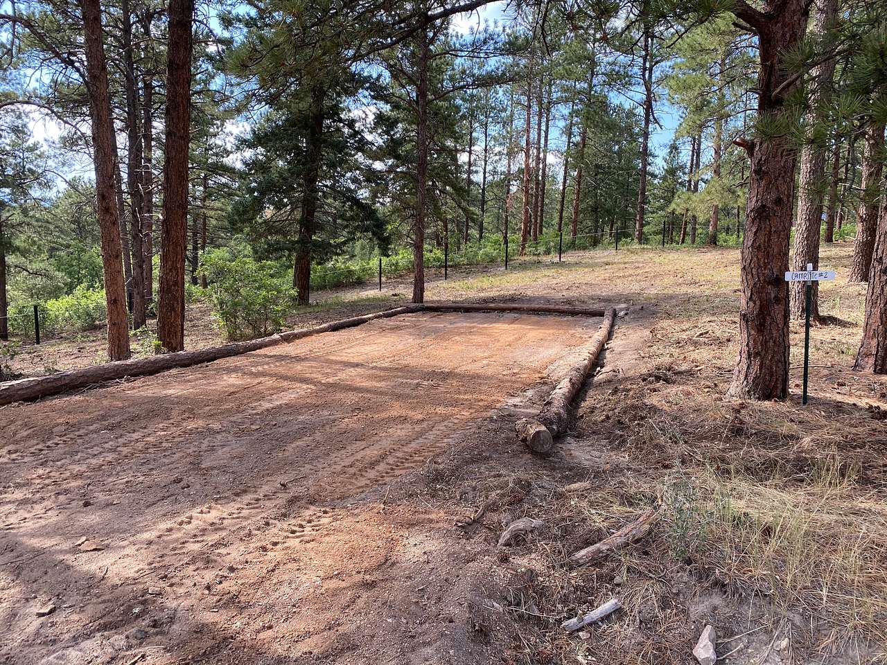 Campsite #2 is located approximately 120 yards from Fox Farm Road. The site is outlined with tree trunks and has a sign. You can pull in or back into the site.
