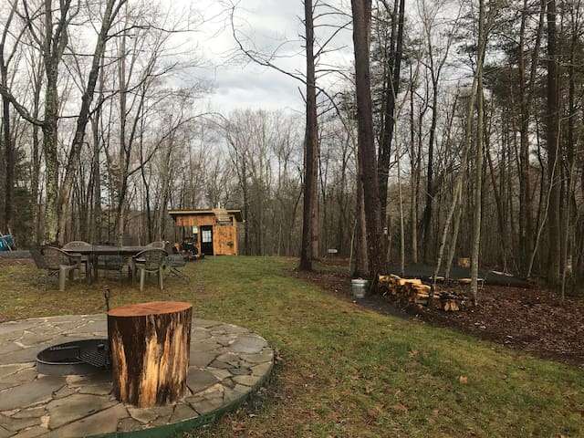 1 acre campsite has a bathhouse with flushing toilet, mini outdoor kitchen, solar outdoor shower, tent pad, table for 8, firepit with grill and horseshoe pit. 