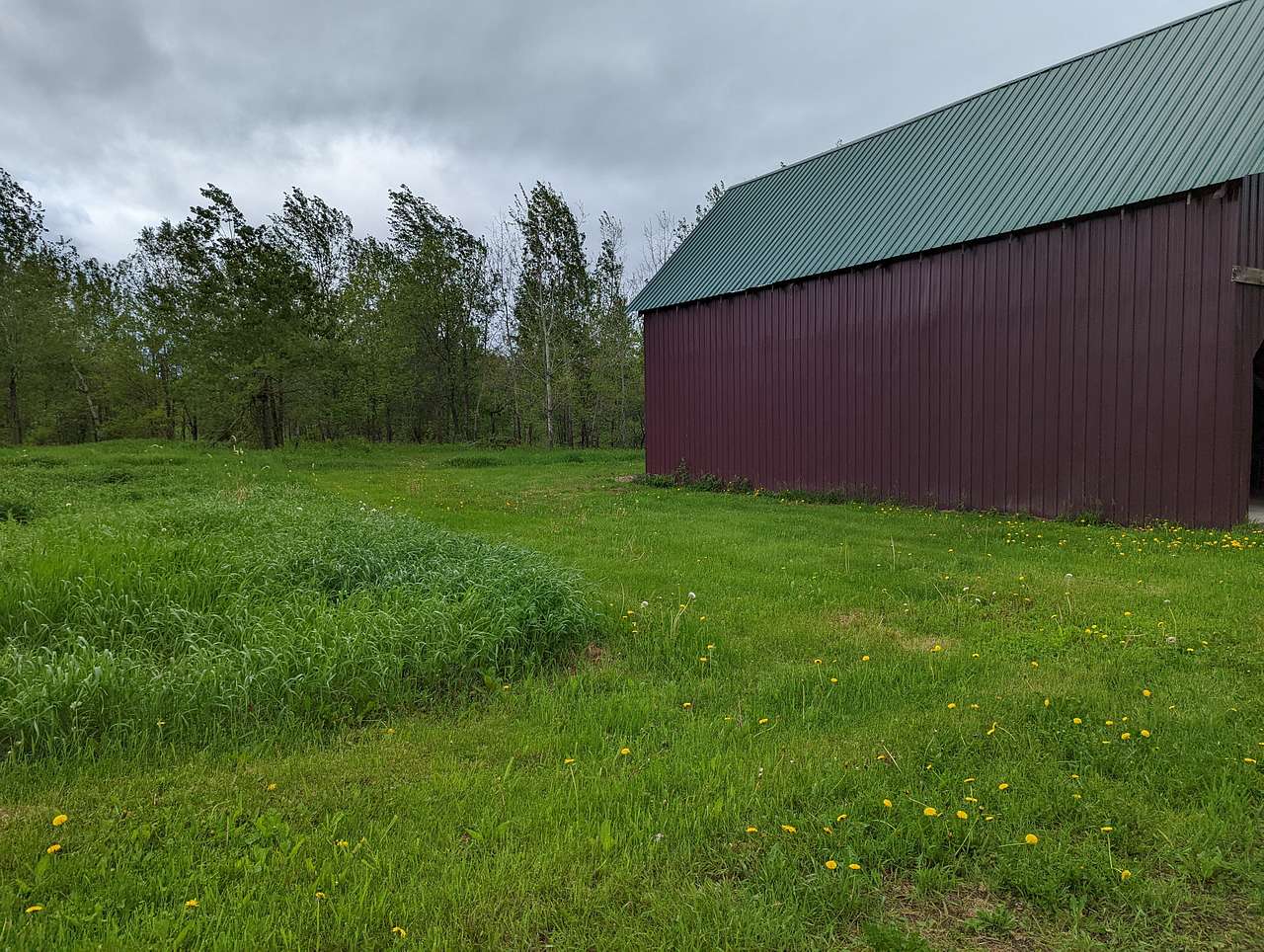RV spot next to barn. 