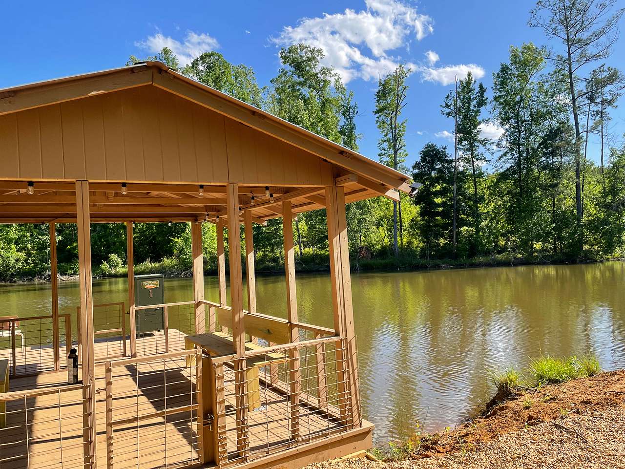 Covered Fishing/boat dock with automatic fish feeder located on the private 1.5 acre lake