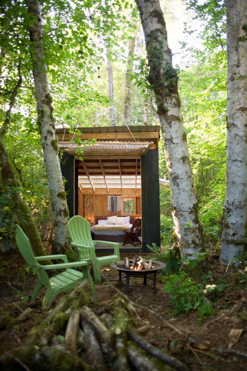 Garage door open. Cabin space opens to the forest. 
Insect screen protects indoor space from bugs.