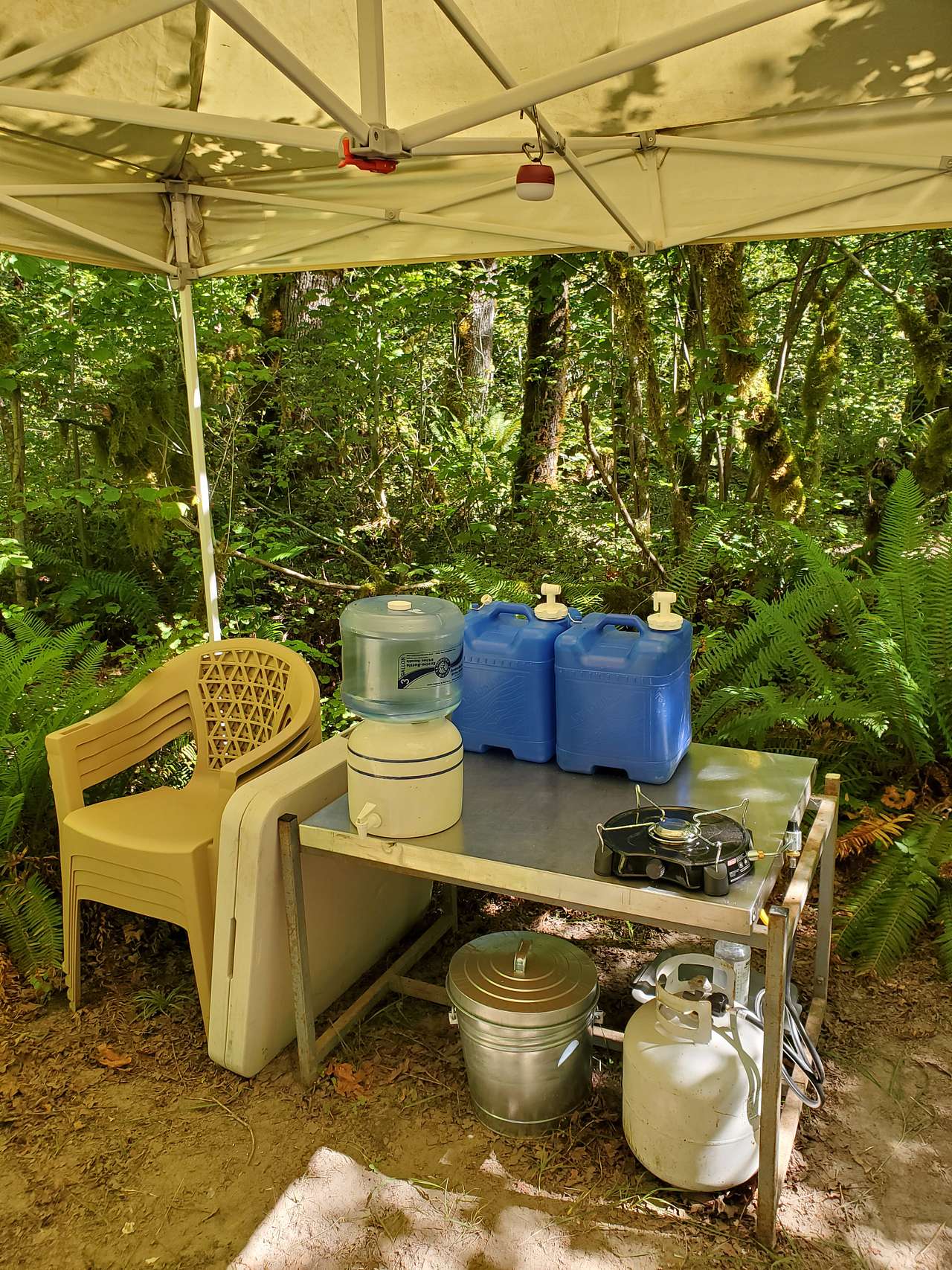 The amenities. Chairs, table, drinking water,hand washing water, stove top, garbage can, and a light.