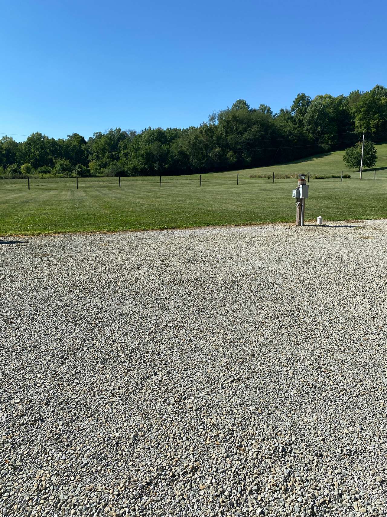 Site #2.   The grass would be behind your camper.
