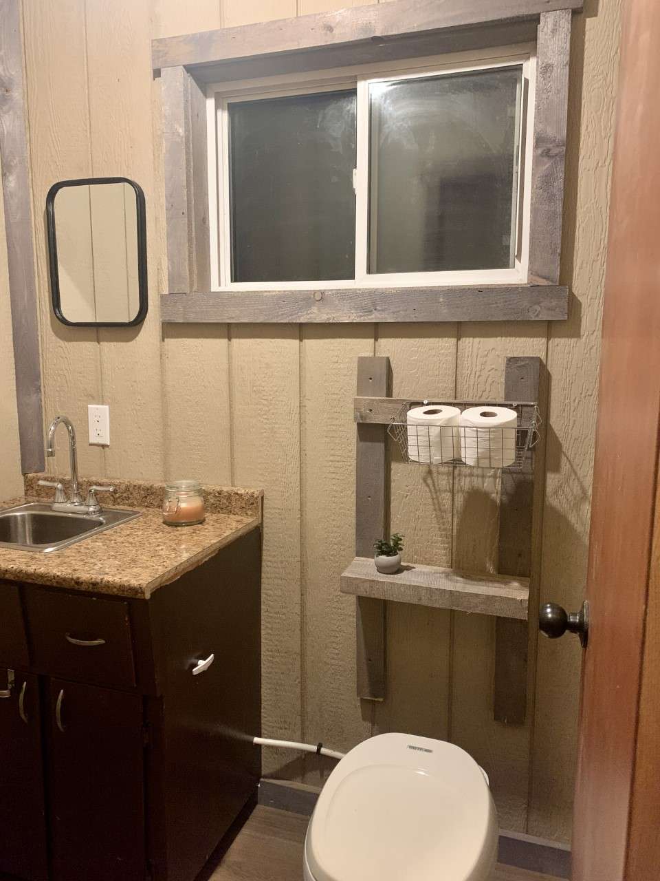 Small half bath with a flushable camper toilet. Needs water in the winter to flush.
