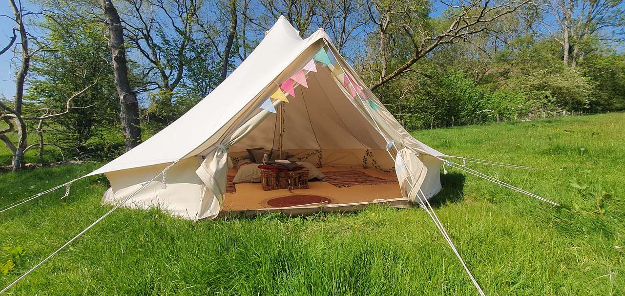 Each 5m bell tent has a double futon with mattress topper, bed linen for the double, and two additional inflatable mattresses (you will need to bring bedding for these.)