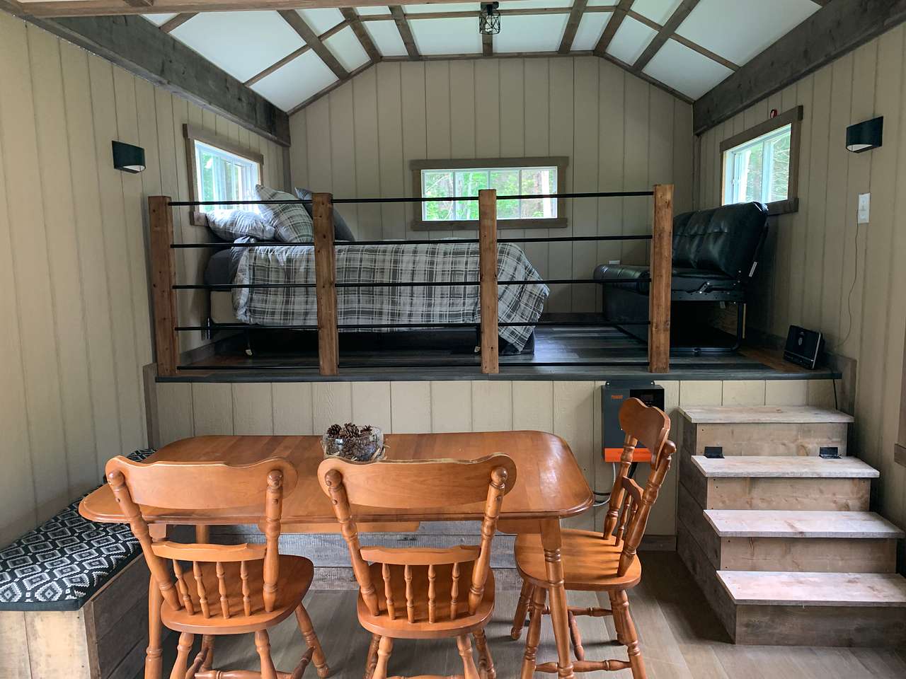 Kitchen table with bench storage seating & upper loft area for sleeping and relaxing.