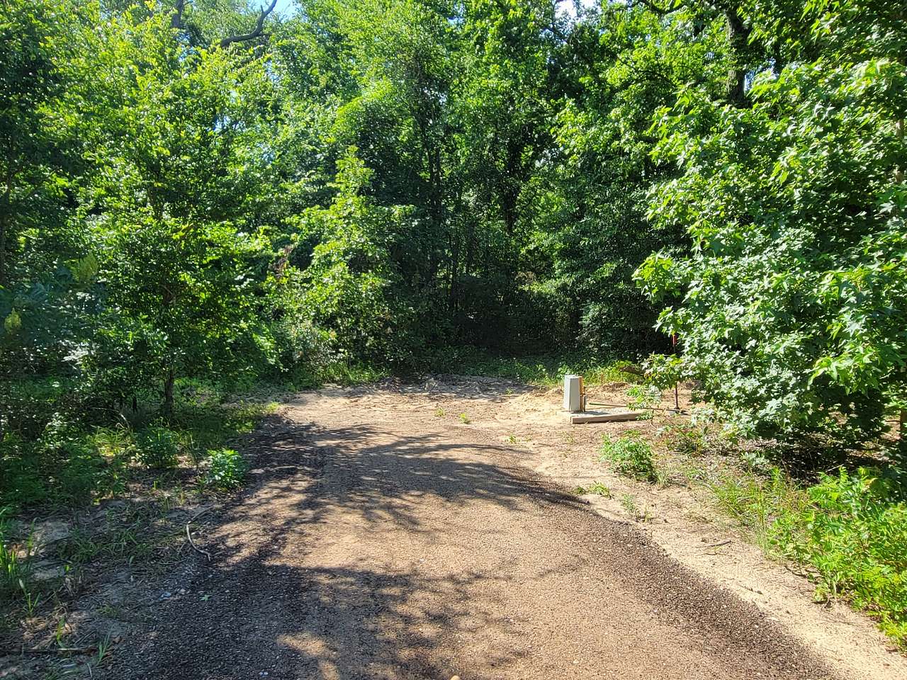 Site A. We've added a picnic table (not shown). Can be for RV or tent camping as there is a clearing to the left at the end of the asphalt.