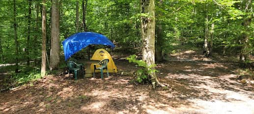 One of the possible camp sites at the main campground.   This is in the middle of the loop in the road at the end.  There are other sites on either side and a trailer situated just below.  There is a primitive camp shower and compost toilet available for campers.   Please make sure you get instructions before using.  or you can also rent the trailer for the perfect larger gathering.    This bathhouse capacity is for only a few people so for larger groups you need to rent trailer or supply duty bags until I can get a portapotty in.   