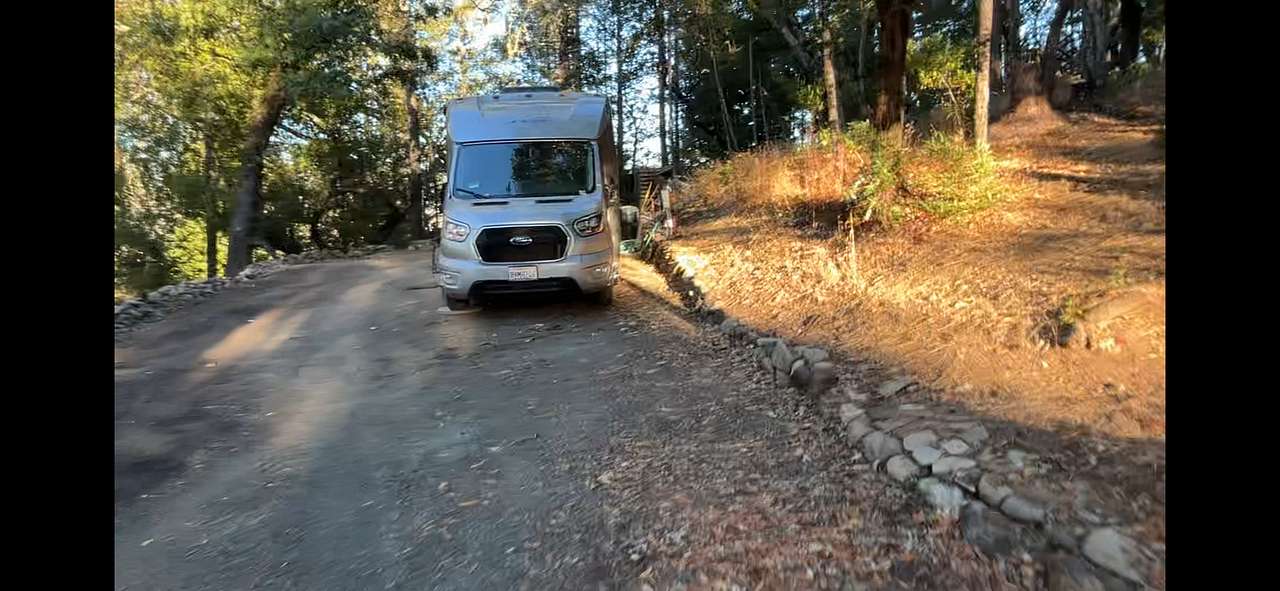 RV parking spot. Our RV (pictured) will be moved to another location on property during your stay.
