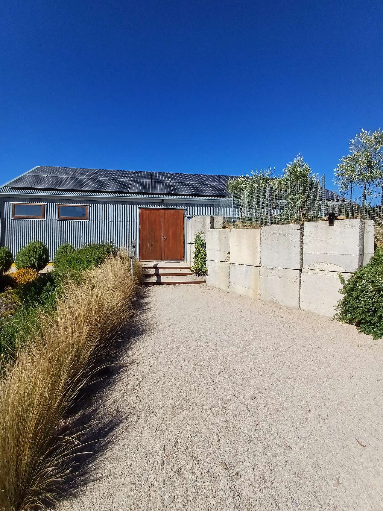 Zero net carbon cellar door front. We export three times the amount of electricity we use. We designed the building to be energy efficient.
