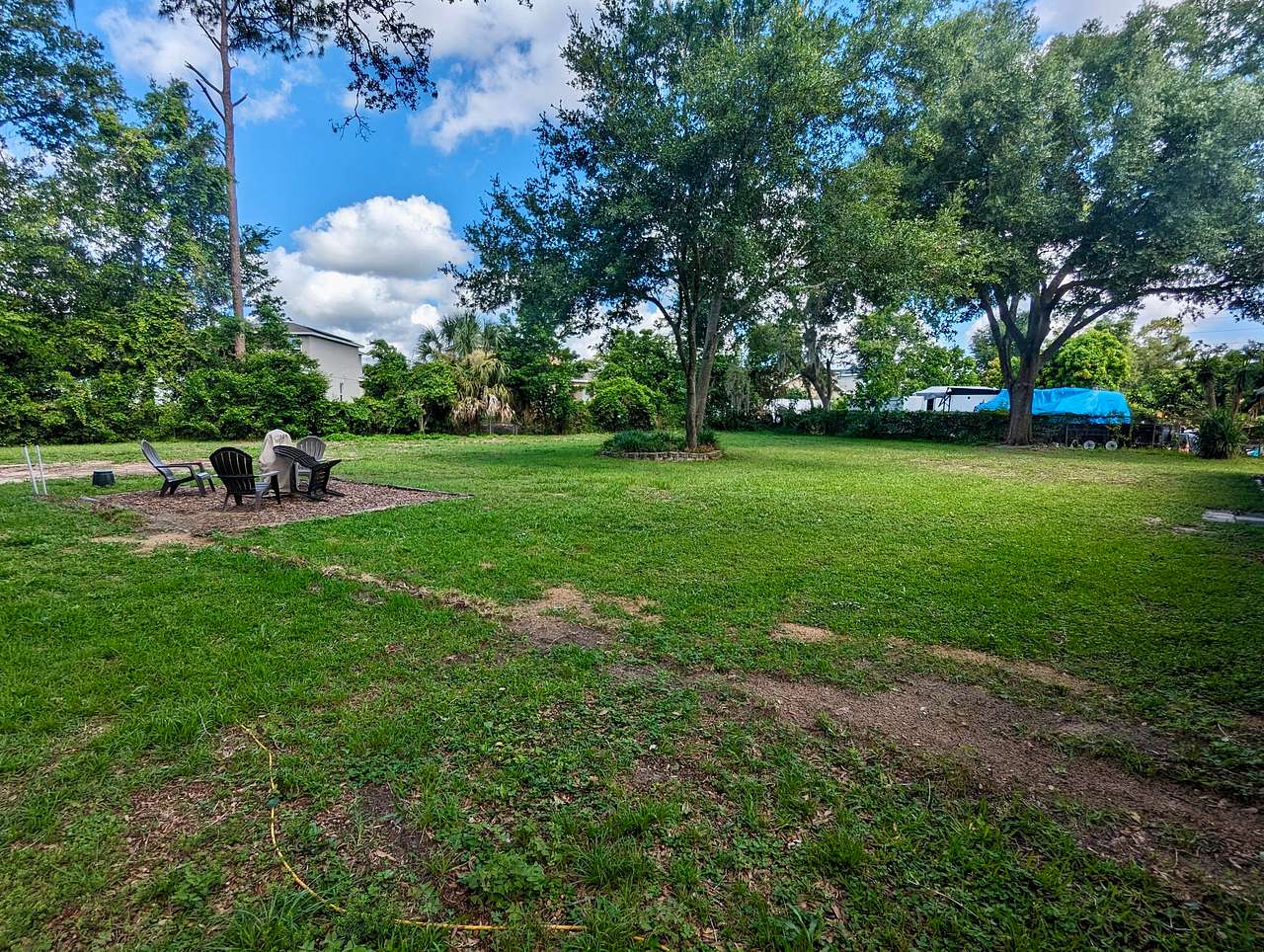 Back yard, park along back fence or by metal barn on concrete slab