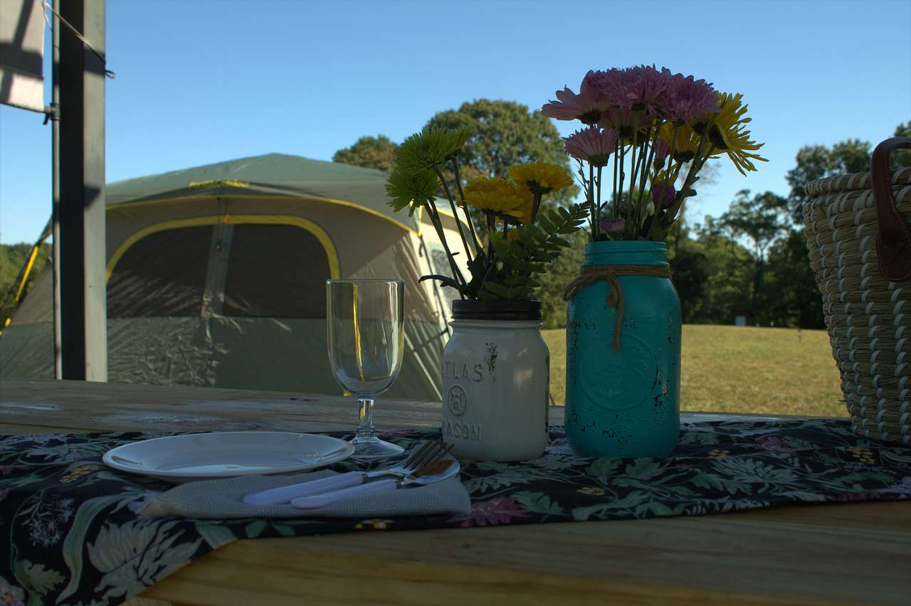 There is a picnic table under the pergola. Pitch your tent at Hill Top Camp any place the grass is mowed 