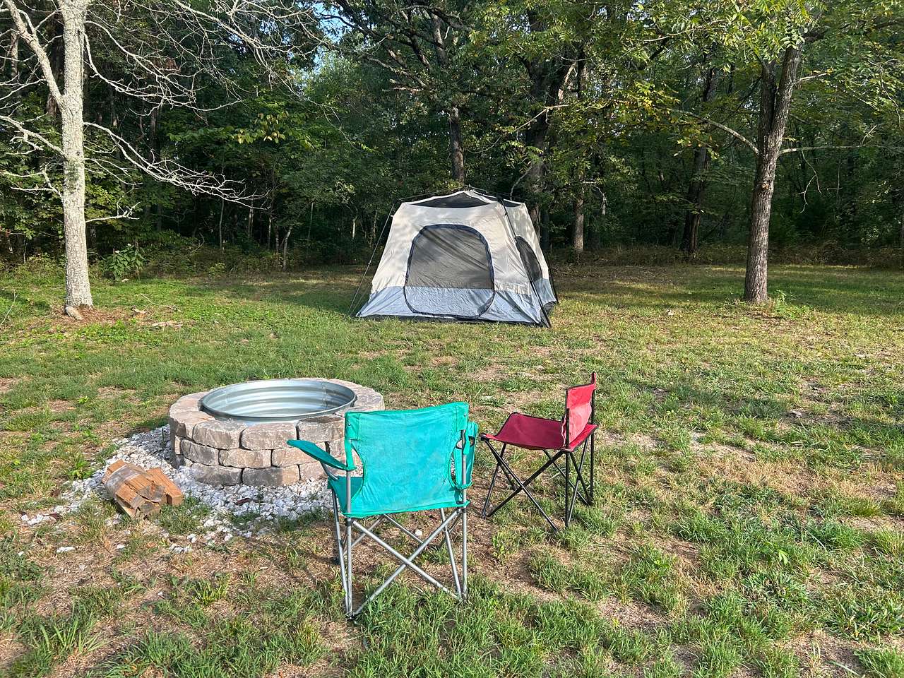 Awesome little site with shade for the tent. Love the bricks around the fire pit!