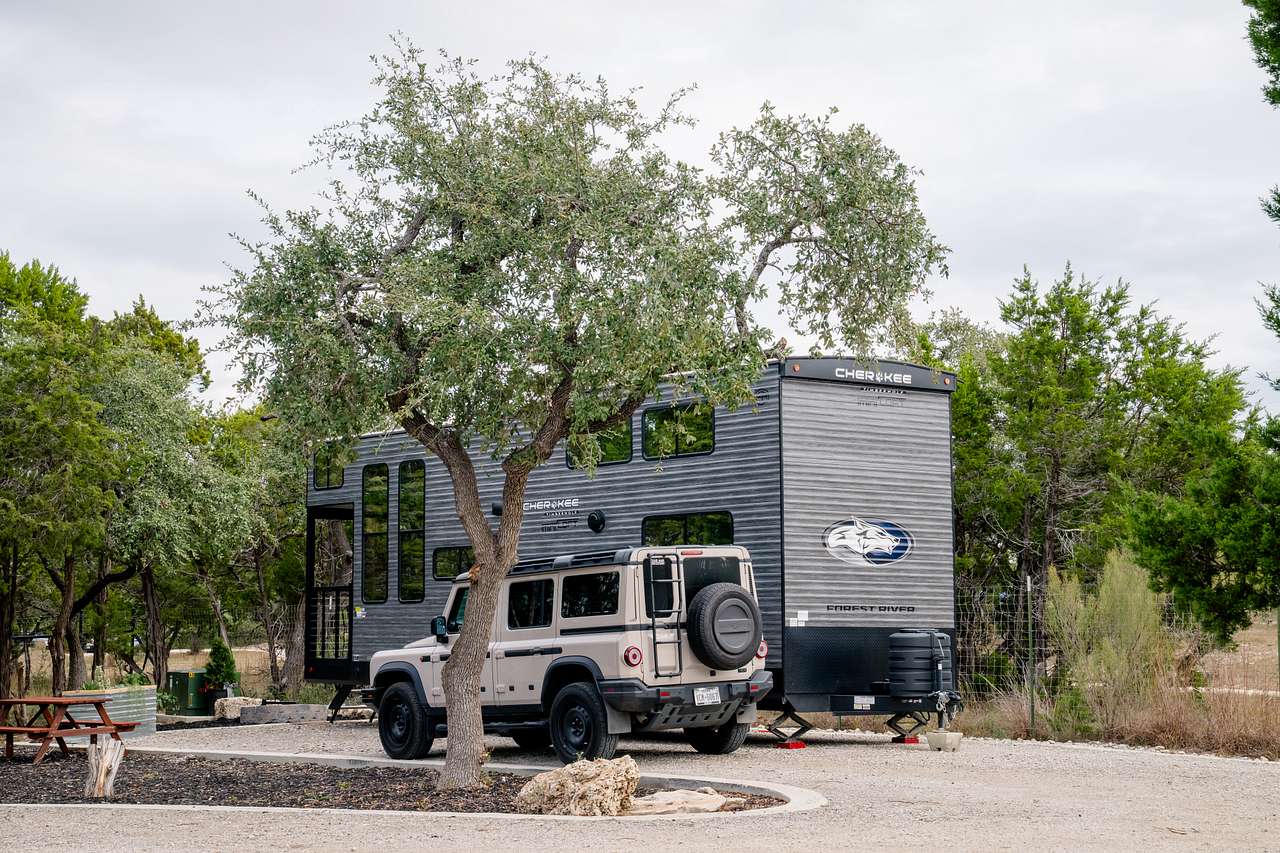 Blancobreeze is located in the back corner of the property nestled around lots of trees, firepit, raised planter, picnic table, and private parking. 