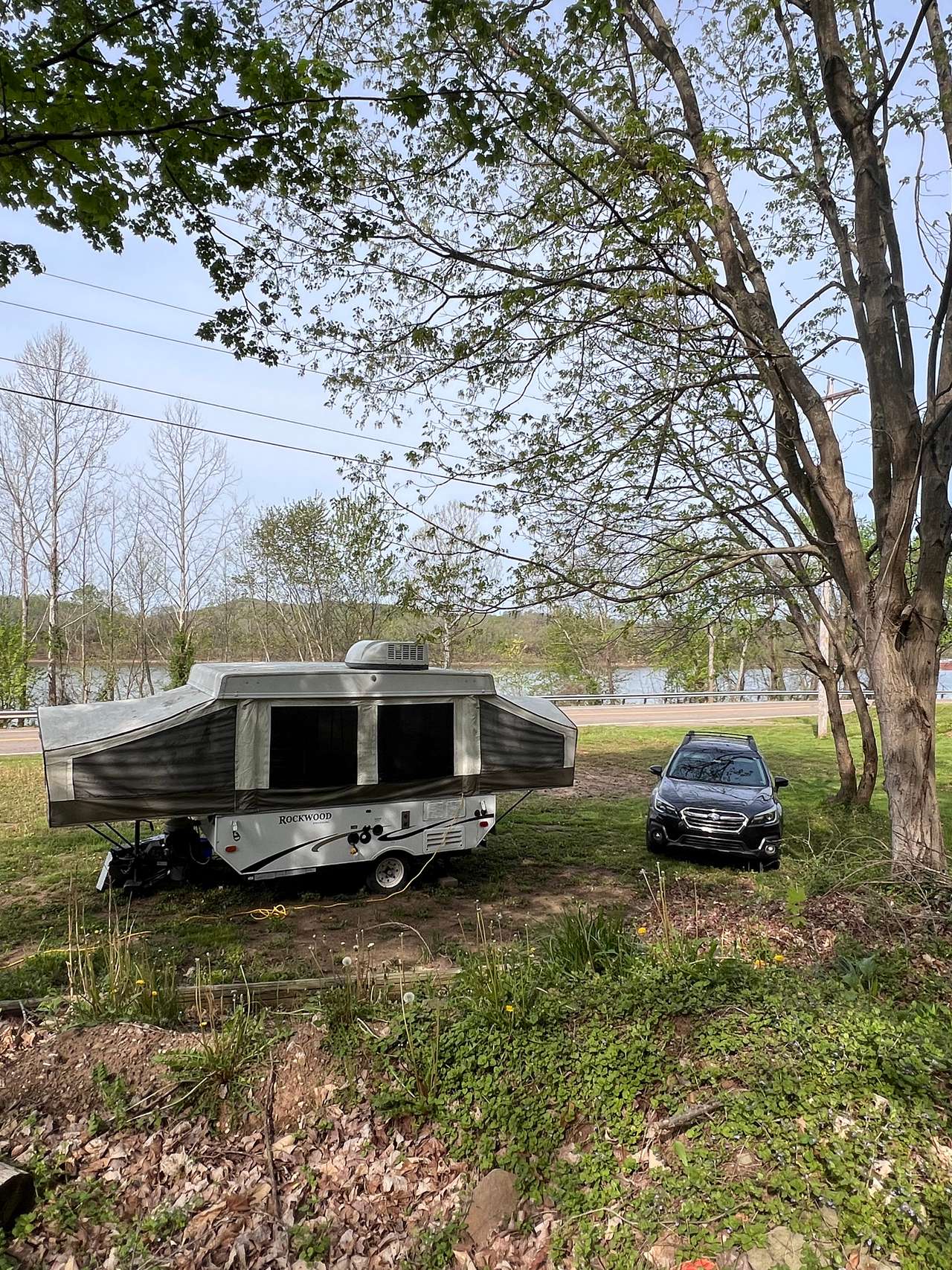 Site with river view.  This is an empty site.  Camper shown only for refe