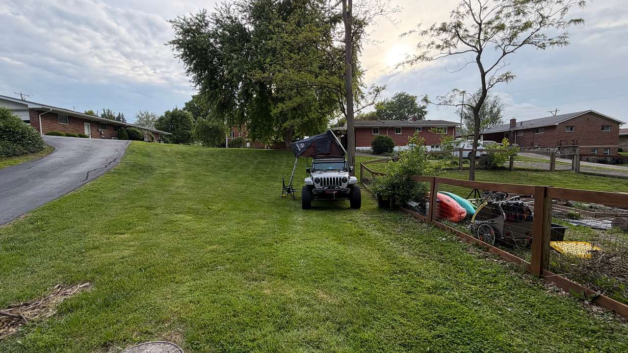 The property is from the fence on the right to the driveway. The back of the property is fairly level, but inclines quite a bit towards the front.