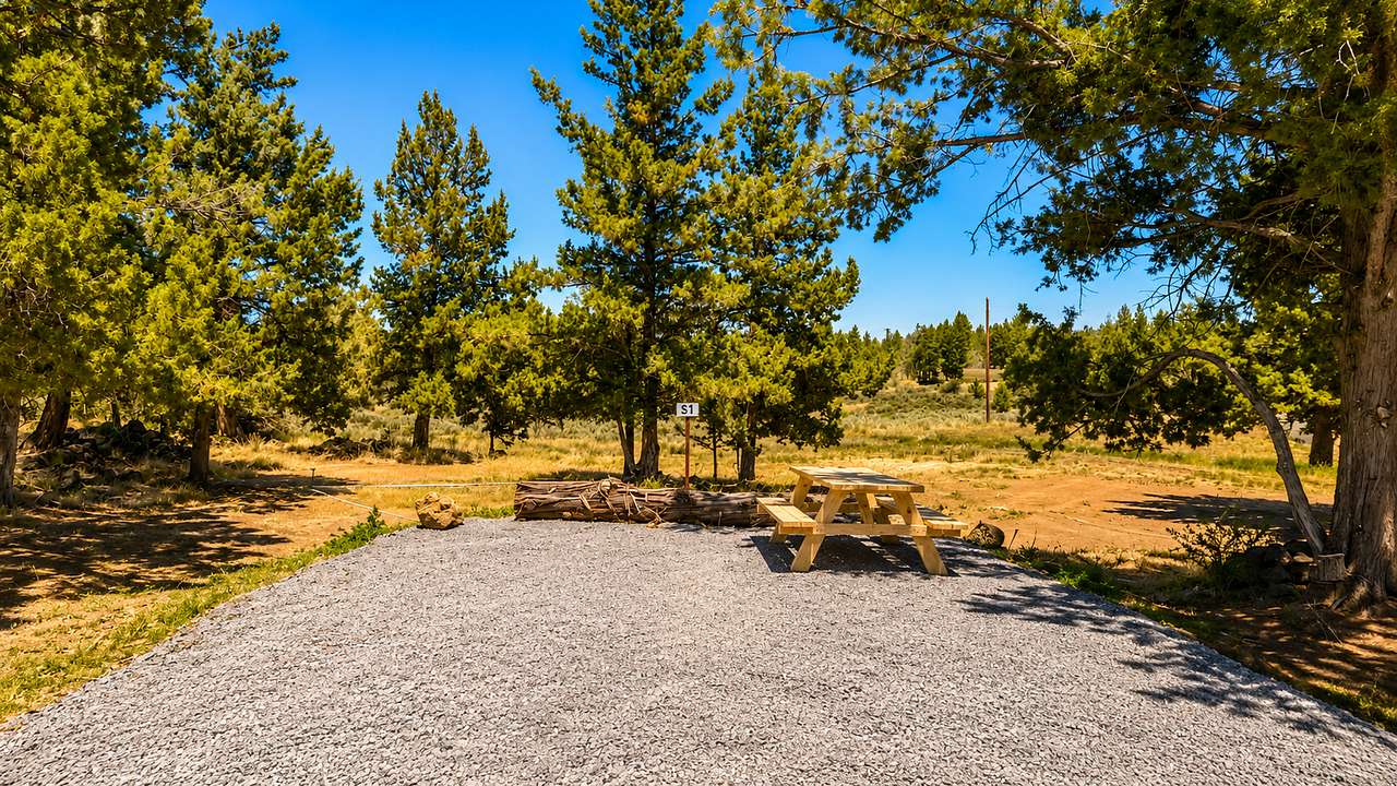 Site S1 | Easy-Access 19×30 Back-In RV Site

Welcome to Roadhouse Ranch Camp, a private, professionally operated campground that is fully permitted for year-round camping in the heart of Central Oregon. Set on 10 peaceful acres just north of Bend, our boutique campground combines the convenience of modern amenities with the beauty of the high desert.

Site S1 is a level 19' × 30' back-in dry camping site designed for camper vans, truck campers, pop-up campers, travel trailers, and RVs up to 30 feet in length. The site includes a private six-person picnic table and is conveniently located near the bathhouse and community gathering areas.

This is a dry camping site with no water, sewer, or electrical hookups, making it an ideal choice for self-contained campers looking for a quiet and comfortable basecamp while exploring Central Oregon.

During your stay, you'll enjoy access to Roadhouse Ranch Camp's shared amenities, including a modern bathhouse with private hot showers, flush toilets, complimentary shampoo, conditioner, and body wash, fresh artesian volcanic well drinking water, and complimentary Starlink Wi-Fi throughout the campground, with the strongest signal near the bathhouse and gazebo.

Relax in the covered community gazebo featuring a propane BBQ grill, outdoor kitchen, picnic seating, cornhole, board games, and card games. An outdoor dishwashing station, communal propane fire pit, disc golf course, and Ghost Ridge Trail await just steps away. Explore our unique volcanic fissure with family-friendly lava rock bouldering, then end the day beneath Central Oregon's spectacular dark skies.

Conveniently located just minutes from Bend, Redmond, Smith Rock State Park, the Deschutes River, Mt. Bachelor, and the Cascade Lakes Scenic Byway, Site S1 is the perfect basecamp for hiking, mountain biking, rock climbing, fishing, skiing, brewery tours, and exploring everything Central Oregon has to offer. Whether you're staying for a weekend or an extended adventure, Roadhouse Ranch Camp offers a peaceful, well-appointed campground experience unlike any other.