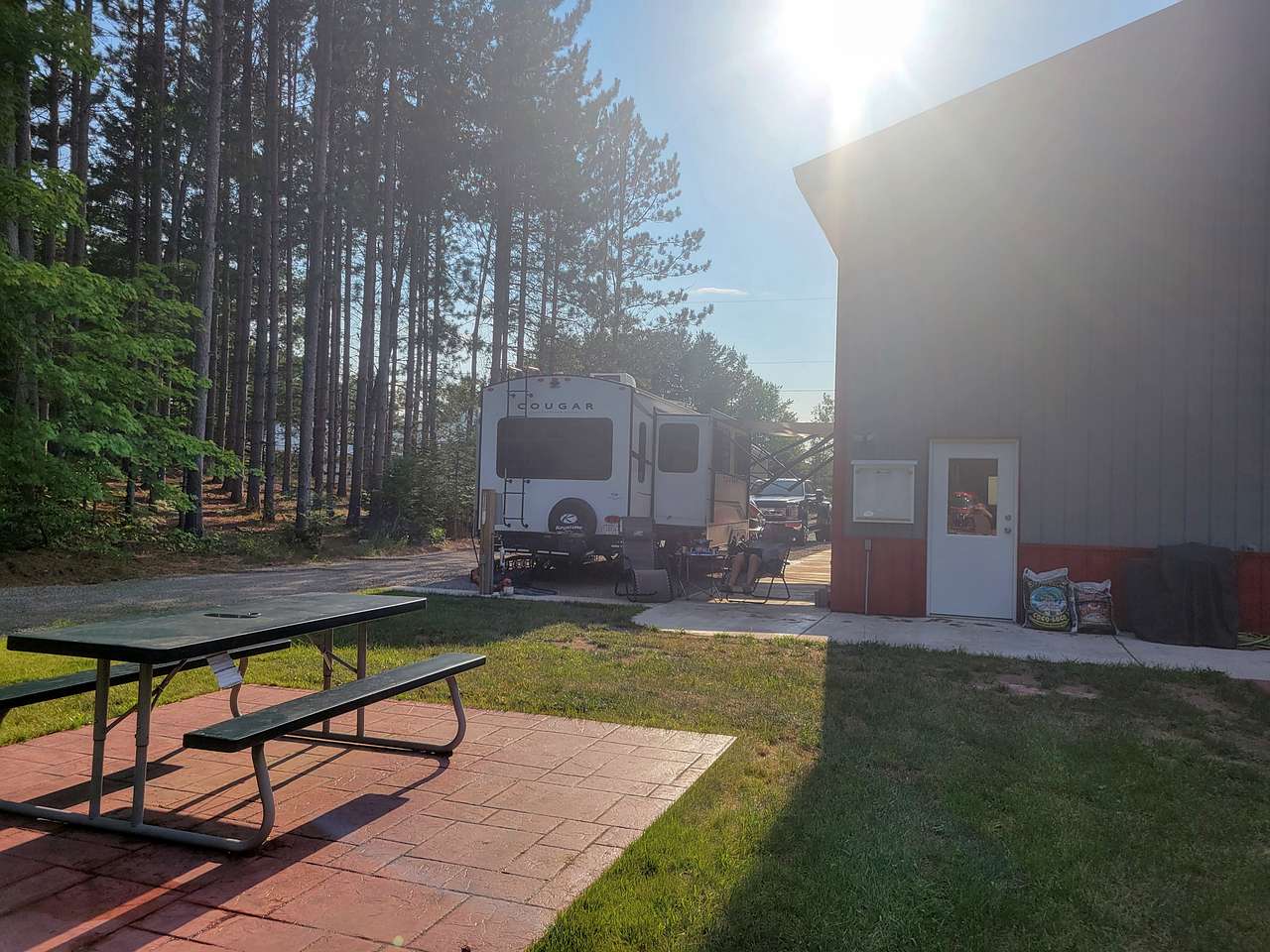 Camper tucked in next to shed.