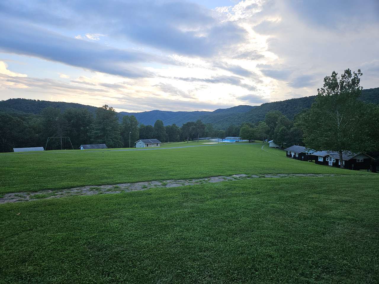 View from the lodge of the cabins.  Swimming pool in distance.  Field for RVs is past the swimming pool (not visible in photo).