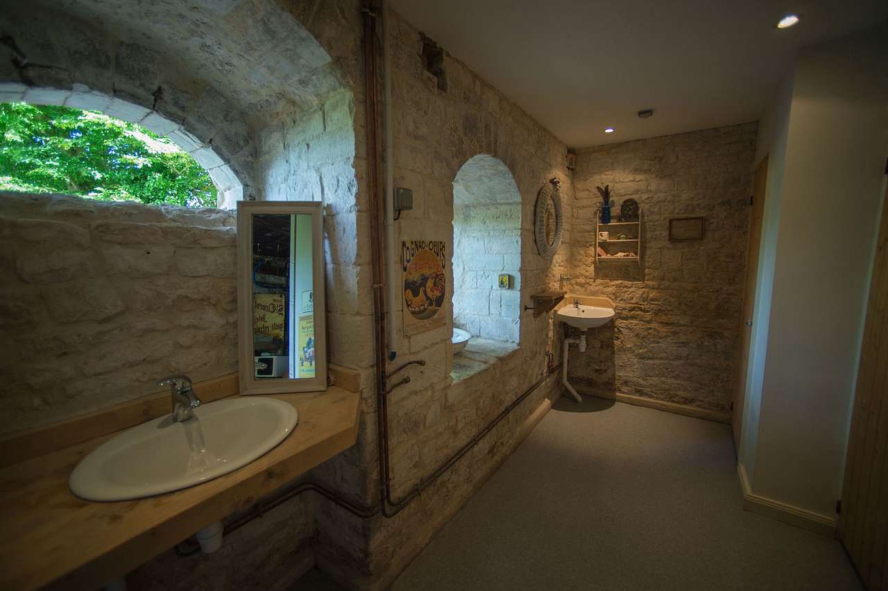 In the grounds of a thousand year old château commissioned by William the Conqueror, lies a brilliant family campsite with a limited number of pitches, a natural swimming pond and a vintage tractor that trundles you to and from your tent.