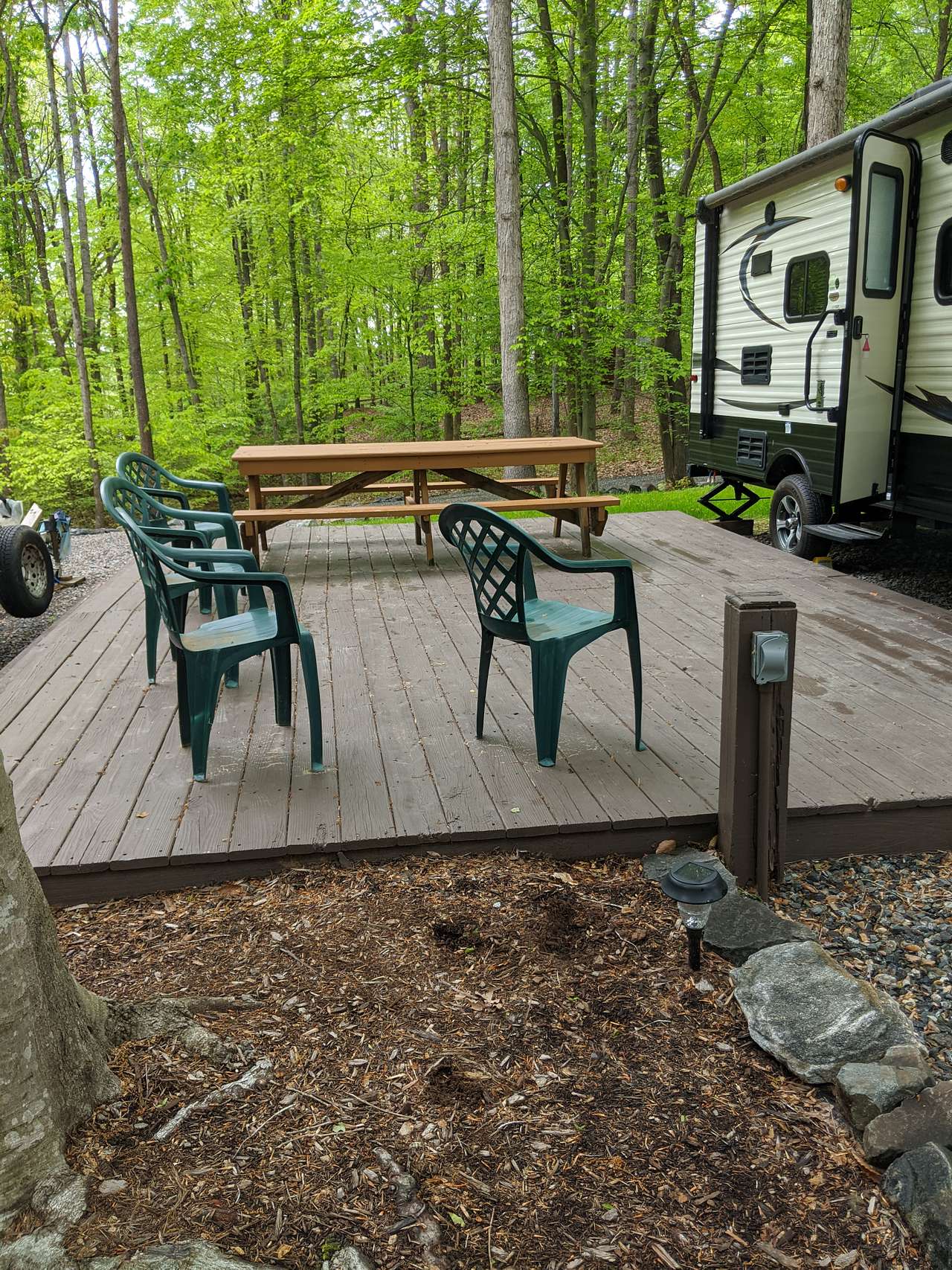 17 Foot Travel trailer parked next to deck