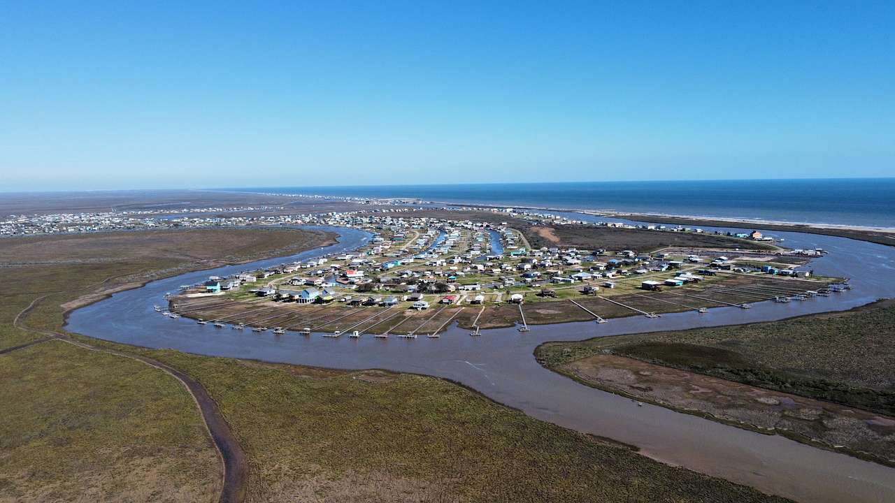 An aerial view from a drone of the neighborhood and the Gulf of Mexico in the background. 
