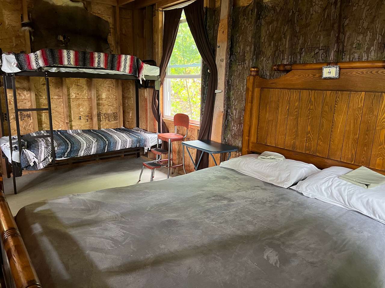 Queen bed and twin bunks in rear of camp