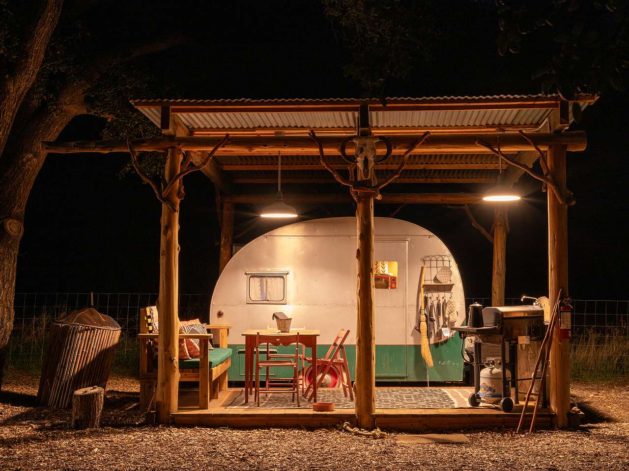 Cozy outdoor kitchen and seating area by the trailer