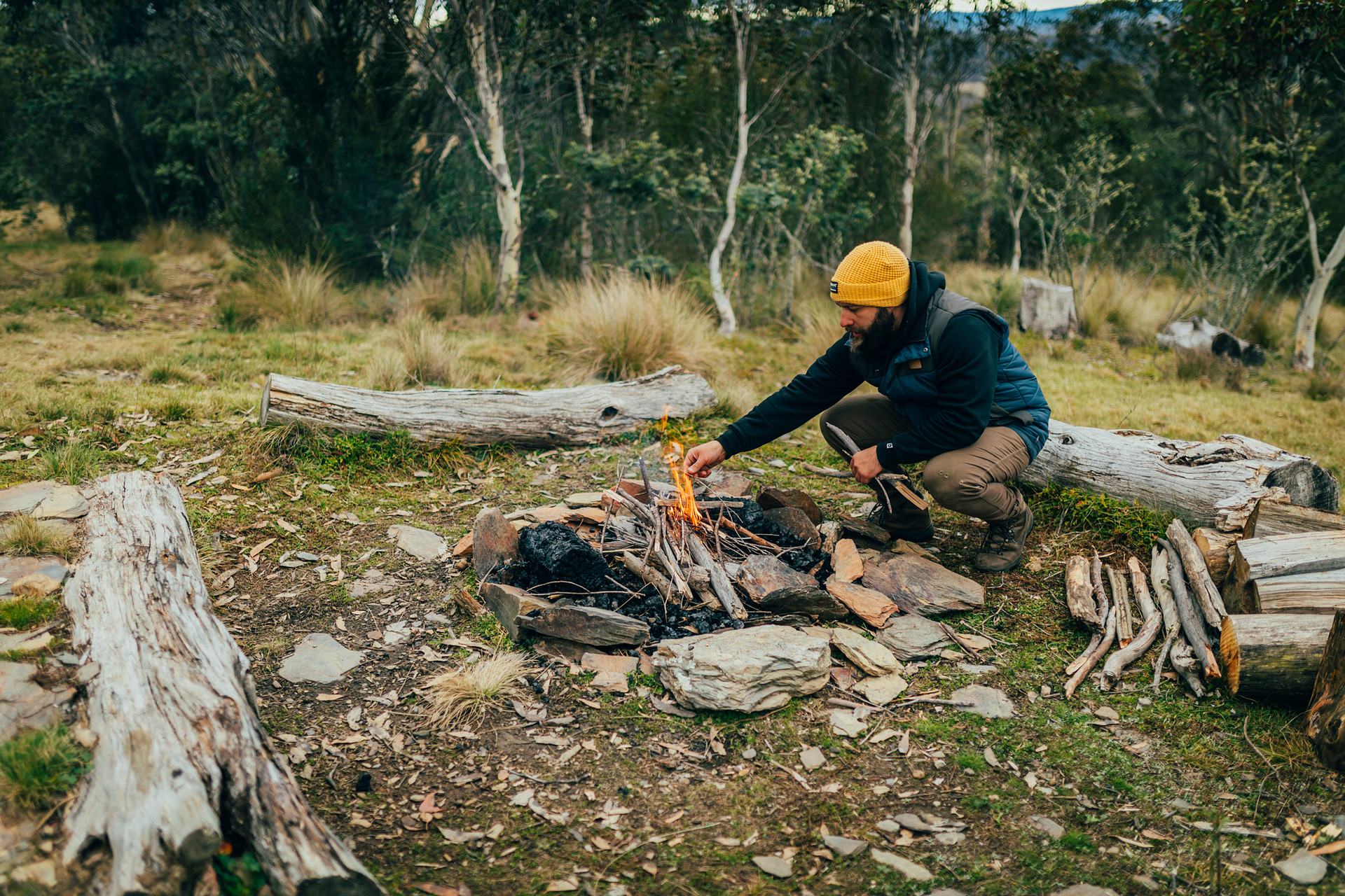 Poking a fire with a stick is one of the life's pleasures