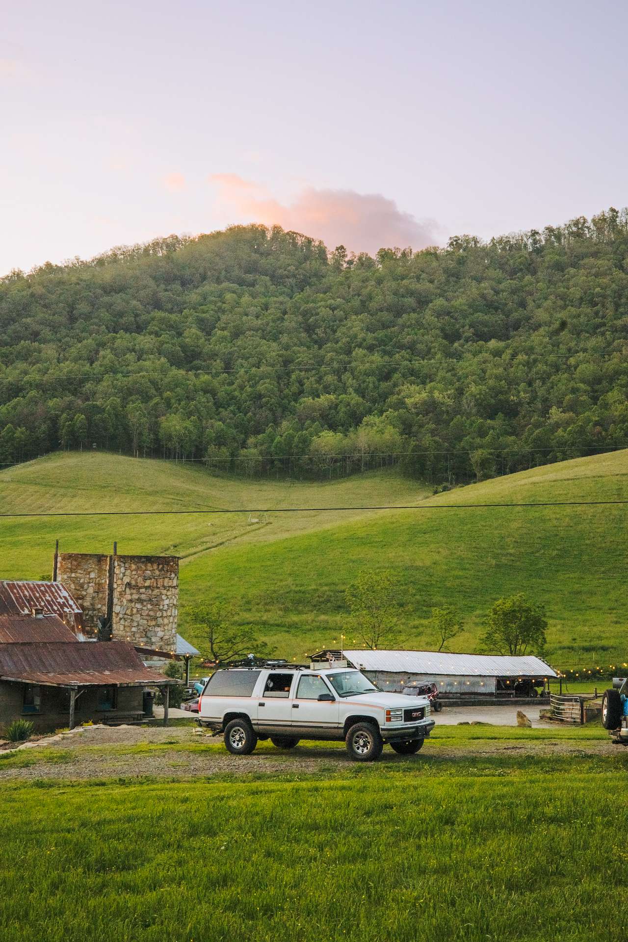 My truck camper sitting at the site at sunset. 