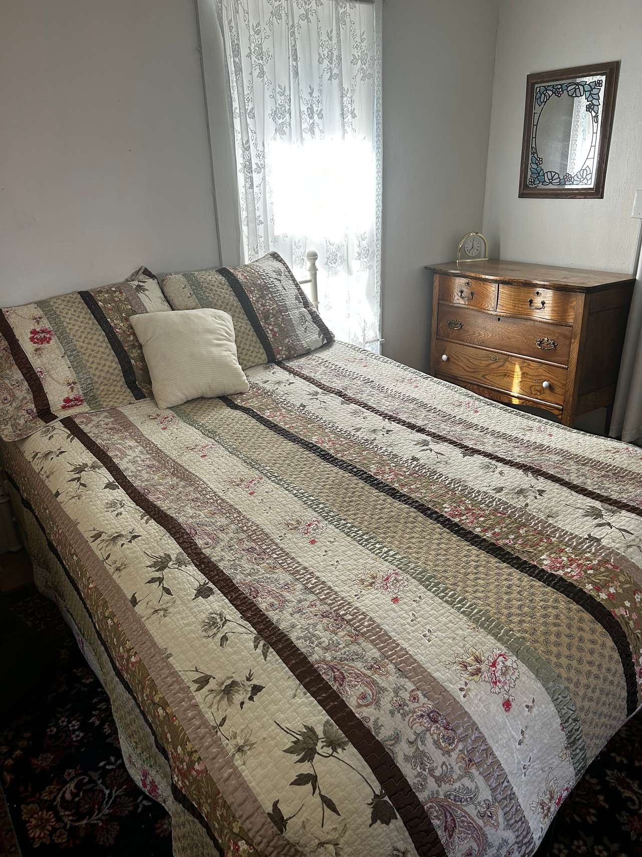 The bedroom sleeps two in this queen bed and is located in the rear of the house. 