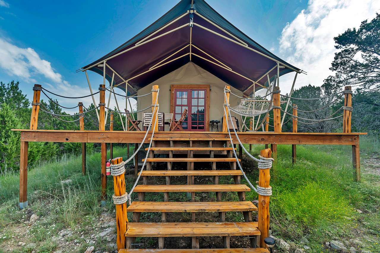 Step into a fully insulated permanent tent with AC & heat, raised 6 ft above the ground, nestled in an exotic animal refuge. This unique retreat lets you unplug, unwind, and immerse yourself in peaceful nature —all without sacrificing comfort!
