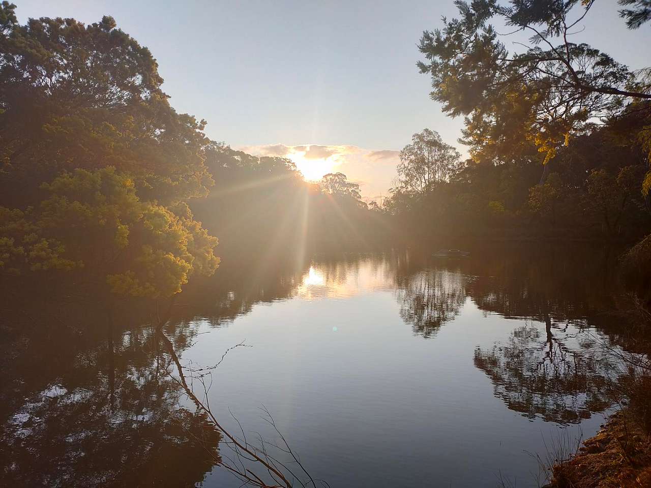 The sun sets over the dam, every day is different 