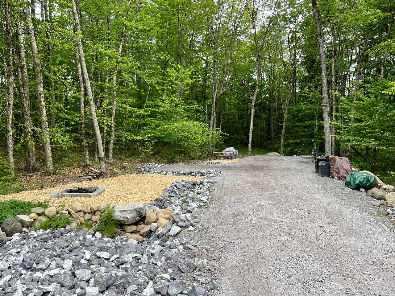 There are two pads at the end of the driveway.  On the RV pad is the potable water, outdoor shower, and electrical, blackwater & grey hookups.