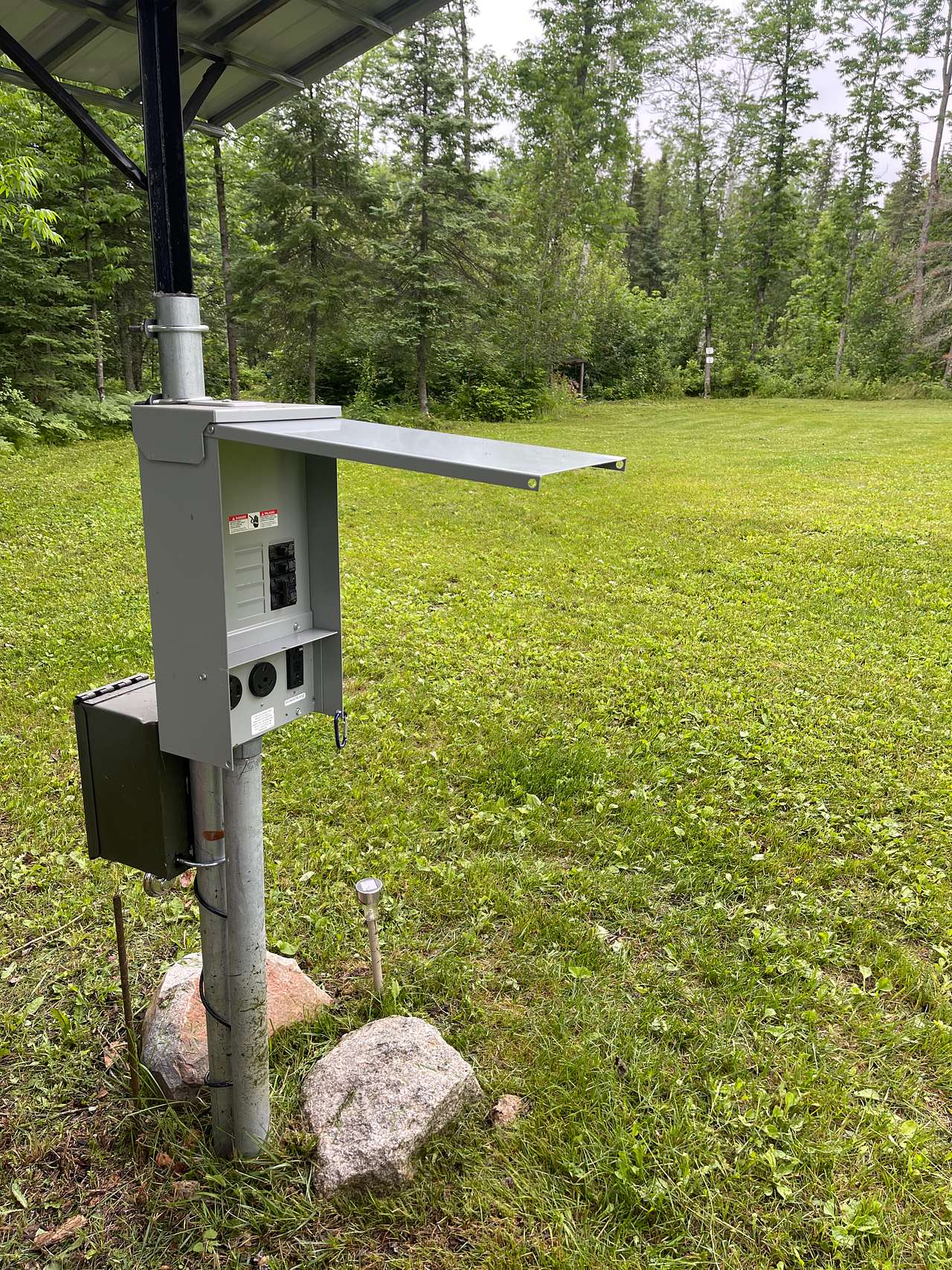 RV power box, 50 amp, 30 amp, and 110 volt plug ins. Shared between RV sites.