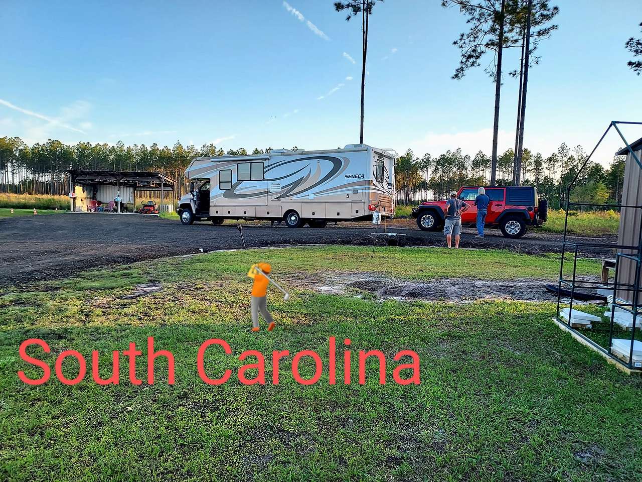 This RV is heading to The electric site left of the shed.