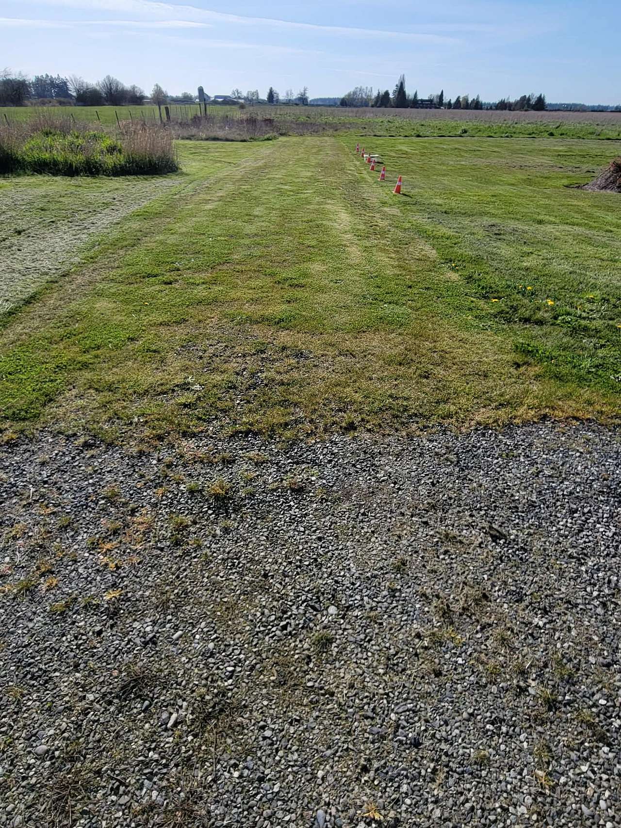 The grass grew up through gravel so it is safe to drive on. When I have a camper staying there I put out orange cones along the right edge. 