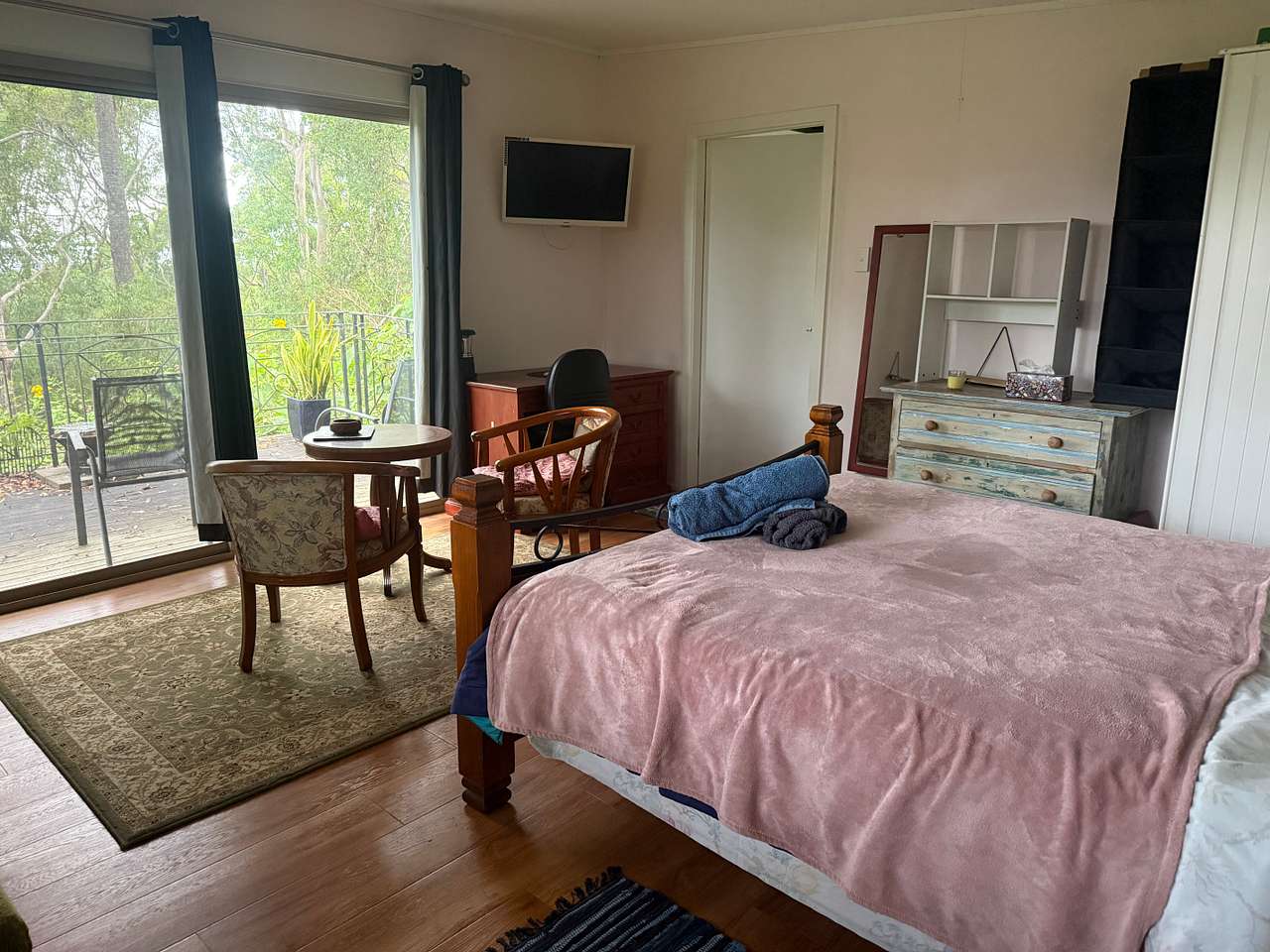 Comfy queen-size bed in open plan bed-living room.
