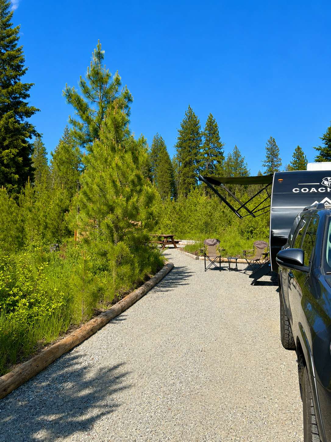 Site 2 is wide allowing for plenty of room for tip outs or patio set ups. Pathway to picnic & fire pit area. 