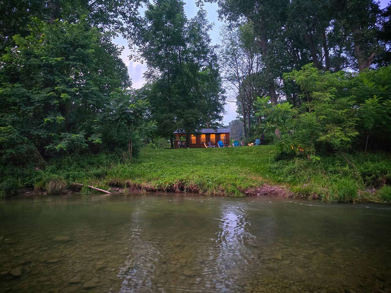 View of cabin from creek summer of 2026. The creek is constantly changing. 