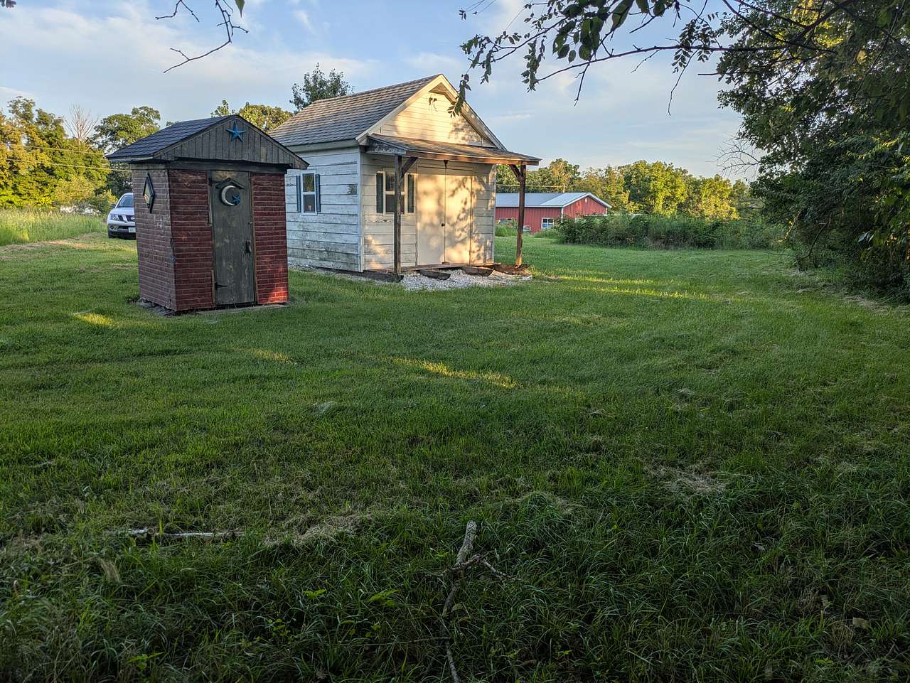 This is a summer kitchen and outhouse on the property. The summer kitchen stays locked but outhouse is available with portable toilet/sink.