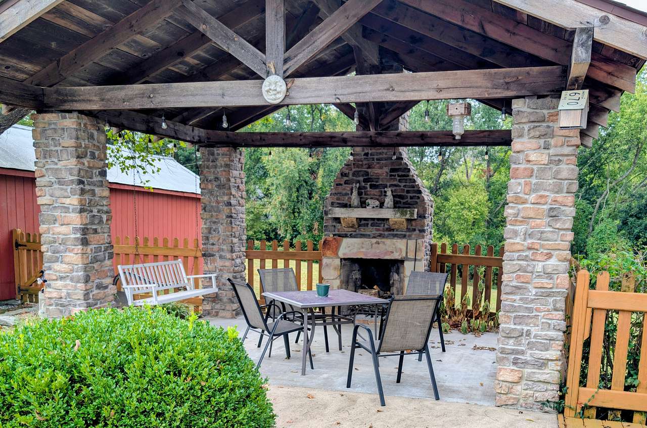 The garden area features an outdoor fireplace.