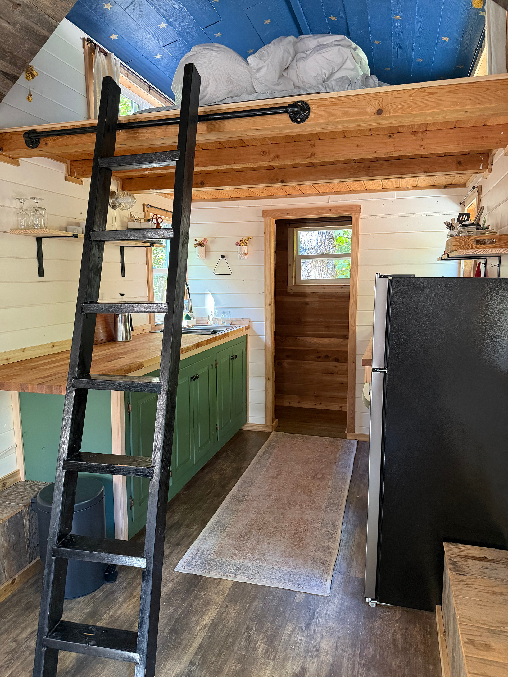 The ladder to the sleeping loft can be moved aside for easier movement during the day time. The cedar lined closet has been remodeled and now features pull out drawers for either pantry or closet use.