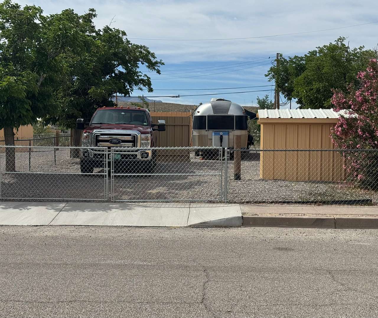 Mesquite Campsite: big rig and tow parking vehicle with easy-entry, retractable sliding fence closed for privacy