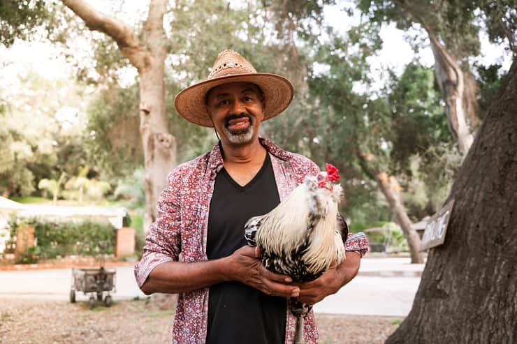 host-holding-a-rooster