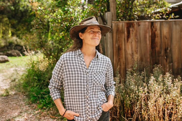 host-in-plaid-by-fence