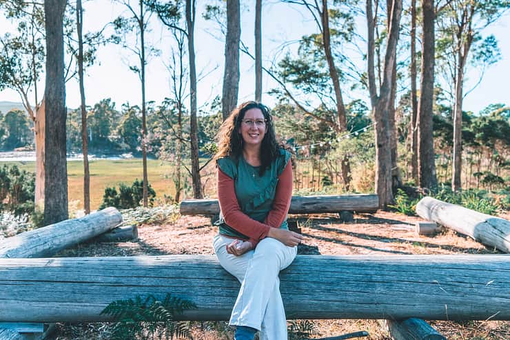 host-sitting-on-log-fence